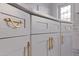 A close up detail of the white cabinets and marble countertops in a recently updated kitchen at 145 174Th Terrace E Dr, Redington Shores, FL 33708