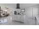An open concept kitchen layout, white island, stainless appliances, and modern design at 145 174Th Terrace E Dr, Redington Shores, FL 33708