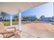 Relaxing covered patio view overlooking the neighborhood street and lush landscaping at 145 174Th Terrace E Dr, Redington Shores, FL 33708
