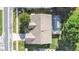 Aerial view of home shows the well-maintained roof, lush landscaping, and inviting screened-in pool area at 1472 Overland Dr, Spring Hill, FL 34608