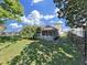 A spacious backyard with a screen-enclosed patio, ideal for outdoor living and recreation at 1472 Overland Dr, Spring Hill, FL 34608