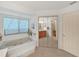En-suite bathroom featuring a soaking tub and mirrored closet at 1472 Overland Dr, Spring Hill, FL 34608