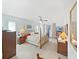Spacious bedroom featuring a brass bed frame and a ceiling fan with sliding glass door to the pool at 1472 Overland Dr, Spring Hill, FL 34608