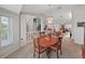 Open dining room showcases wood table, chandelier with views to other living spaces at 1472 Overland Dr, Spring Hill, FL 34608