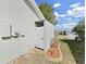 Outdoor shower next to the house with a door for privacy at 1472 Overland Dr, Spring Hill, FL 34608