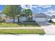 Charming single-story home featuring a well-manicured lawn and a two-car garage at 1472 Overland Dr, Spring Hill, FL 34608