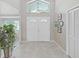 Spacious foyer features tile flooring, a high ceiling, and ample natural light, providing an inviting entry to the home at 1472 Overland Dr, Spring Hill, FL 34608