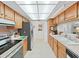 Efficient kitchen features stainless steel appliances and tile flooring for easy maintenance at 1472 Overland Dr, Spring Hill, FL 34608