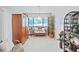 Cozy living room nook with wicker furniture, a tile floor, and large bright windows at 1472 Overland Dr, Spring Hill, FL 34608