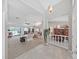 Open-concept living space showcases high ceilings, neutral tones, and seamless flow to outdoor lanai, ideal for modern living at 1472 Overland Dr, Spring Hill, FL 34608
