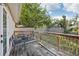 Backyard deck with wood railing and seating area with ample sunlight and shade at 1614 E Nome St, Tampa, FL 33604