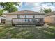 Exterior view of a home showcasing a wood deck and a spacious backyard at 1614 E Nome St, Tampa, FL 33604
