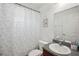Bathroom featuring a shower-tub combo, granite sink, and neutral decor at 1614 E Nome St, Tampa, FL 33604