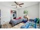 Bedroom with wood look tile floors, twin beds, and a ceiling fan at 1614 E Nome St, Tampa, FL 33604
