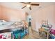Bright bedroom with wood look tile floors, bunk beds, desk and a ceiling fan at 1614 E Nome St, Tampa, FL 33604