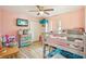 Bright bedroom with wood look tile floors, bunk beds, storage and a ceiling fan at 1614 E Nome St, Tampa, FL 33604