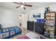 Bedroom with wood look tile floors, twin beds, closet, and a ceiling fan at 1614 E Nome St, Tampa, FL 33604
