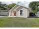 Side view of a cozy single-story home with a well-maintained lawn and private backyard at 1614 E Nome St, Tampa, FL 33604