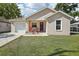 Charming single-story home with a well-maintained lawn, front porch, and a single-car garage at 1614 E Nome St, Tampa, FL 33604
