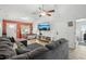 Inviting living room with tile floors, a cozy sectional sofa, and plenty of natural light at 1614 E Nome St, Tampa, FL 33604