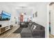 Bright living room with tile floors, neutral walls, and a comfortable sectional sofa at 1614 E Nome St, Tampa, FL 33604