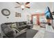 Spacious living room with tile floors, a large sectional sofa, and a ceiling fan at 1614 E Nome St, Tampa, FL 33604