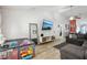 Open-concept living room featuring tile floors, a ceiling fan, and modern decor at 1614 E Nome St, Tampa, FL 33604