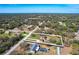 Aerial view showing home layout within its property lines surrounded by wooded areas in residential neighborhood at 16247 Fringe Tree Dr, Spring Hill, FL 34610
