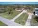 An aerial view of a home on a spacious lot with mature trees and a long driveway at 16247 Fringe Tree Dr, Spring Hill, FL 34610
