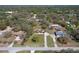Bird's-eye view of a home in a wooded neighborhood, showcasing its spacious lot and surroundings at 16247 Fringe Tree Dr, Spring Hill, FL 34610