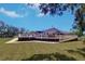 Expansive backyard view featuring a large deck, lush lawn, and a well-maintained landscape at 16247 Fringe Tree Dr, Spring Hill, FL 34610