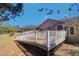 Well-maintained backyard features a spacious wooden deck, perfect for relaxation and entertainment at 16247 Fringe Tree Dr, Spring Hill, FL 34610