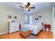 Cozy bedroom with ceiling fan, white furnishings, and nautical decor to create a relaxing atmosphere at 16247 Fringe Tree Dr, Spring Hill, FL 34610