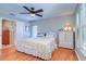 Cozy bedroom featuring hardwood floors, soft natural light, and simple decor creating a serene atmosphere at 16247 Fringe Tree Dr, Spring Hill, FL 34610