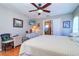 Inviting bedroom featuring hardwood floors, TV, and a glimpse of the Primary bathroom at 16247 Fringe Tree Dr, Spring Hill, FL 34610