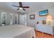 Comfortable bedroom with a view of the outdoors, featuring hardwood floors and light and bright decor at 16247 Fringe Tree Dr, Spring Hill, FL 34610