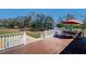 Outdoor deck with table and chairs, overlooking lush greenery, perfect for outdoor dining at 16247 Fringe Tree Dr, Spring Hill, FL 34610
