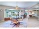 Bright dining area with a large window, comfortable seating, and seamless access to the living spaces at 16247 Fringe Tree Dr, Spring Hill, FL 34610