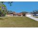 Charming single-story home with a stone facade, large lawn, and detached garage, perfect for Gathering living at 16247 Fringe Tree Dr, Spring Hill, FL 34610