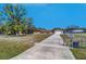 Sprawling single-story home with detached garage and a long driveway on a well-maintained lawn at 16247 Fringe Tree Dr, Spring Hill, FL 34610