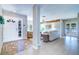Elegant foyer with tiled floor, a decorative rug, and an open view to the living room at 16247 Fringe Tree Dr, Spring Hill, FL 34610