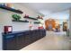 Hallway with shelving and a view of the dining area and kitchen with stainless steel appliances at 16247 Fringe Tree Dr, Spring Hill, FL 34610
