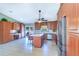 Spacious kitchen featuring an island with seating, stainless appliances, and a separate coffee bar area at 16247 Fringe Tree Dr, Spring Hill, FL 34610