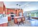 Bright kitchen with an island, stainless appliances, adjacent dining area, and view of the outdoors at 16247 Fringe Tree Dr, Spring Hill, FL 34610