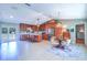 Spacious kitchen with an island, seating, stainless steel appliances, and seamless access to the dining area at 16247 Fringe Tree Dr, Spring Hill, FL 34610