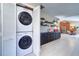Convenient laundry closet with stacked washer and dryer, plus built-in storage cabinets at 16247 Fringe Tree Dr, Spring Hill, FL 34610