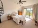 Bright bedroom with balcony overlooking water, neutral tones and ceiling fan at 1720 Lighthouse S Ter # 8, South Pasadena, FL 33707