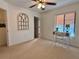 Bedroom with ceiling fan, decorative mirror, desk and chair set at 1720 Lighthouse S Ter # 8, South Pasadena, FL 33707