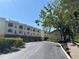 View of the building's exterior showing multiple units and a well-maintained driveway on a sunny day at 1720 Lighthouse S Ter # 8, South Pasadena, FL 33707