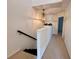 Upstairs hallway featuring chandelier and natural light at 1720 Lighthouse S Ter # 8, South Pasadena, FL 33707